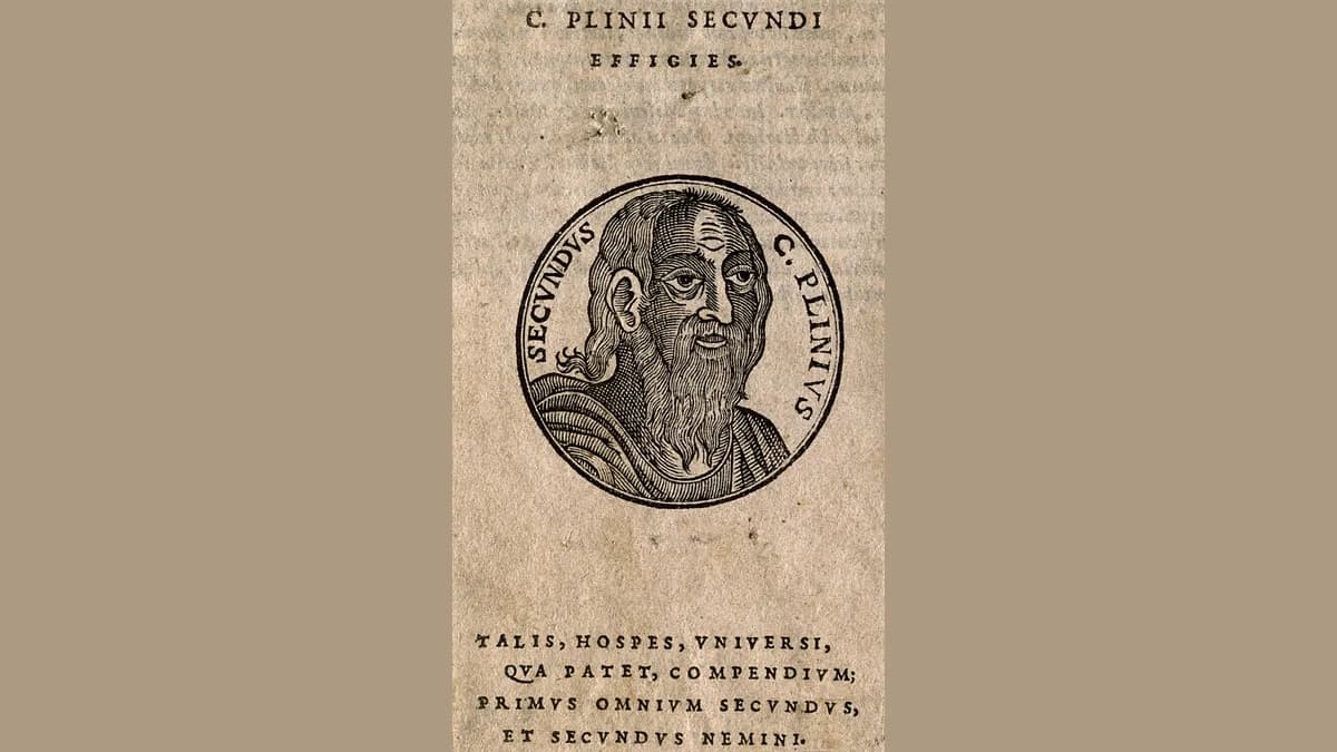 Xilogravura com o busto de um homem barbado e calvo dentro de um medalhão circular, com a inscrição C. Plinius Secundus ao redor e versos em latim abaixo.